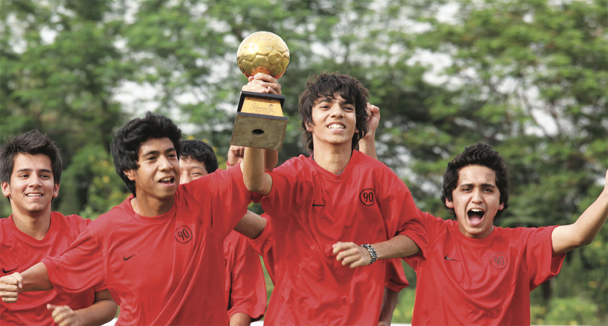 Students celebrating with trophy